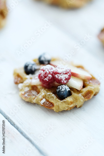 Breakfast of tasty Waffles with berries on a wooden surface