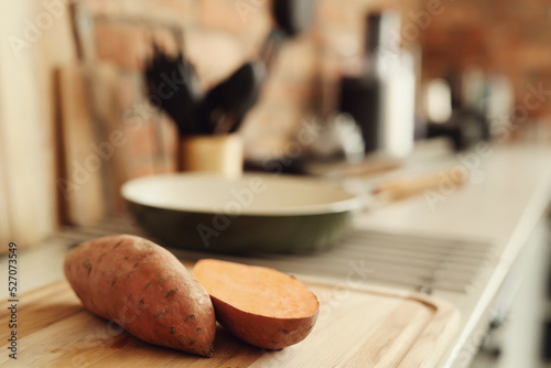 Fresh, sweet, sliced sweet potato on the kitchen table photo