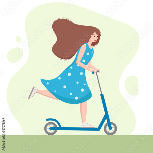 Young woman with beautiful brown hair riding kick scooter. Nice girl in blue dress. Sports outdoor activity, active vacation. Personal electric and eco urban transport. Healthy lifestyle concept. 