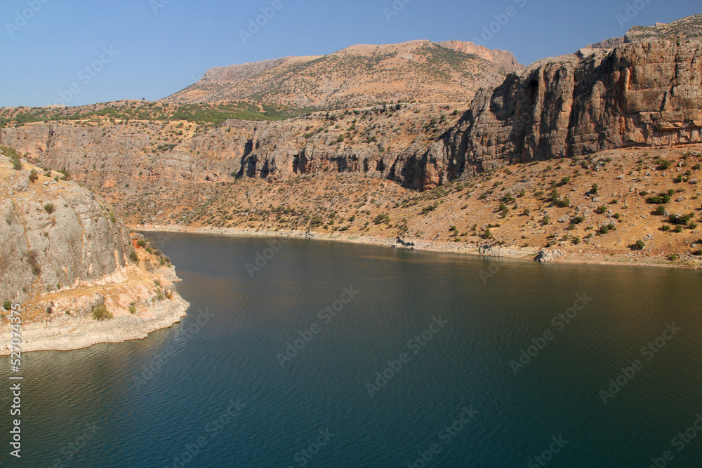 Landscape with mountains and smooth surface of Euphrates River near Nissibi Bridge in Southeast Anatolia region of Turkey	