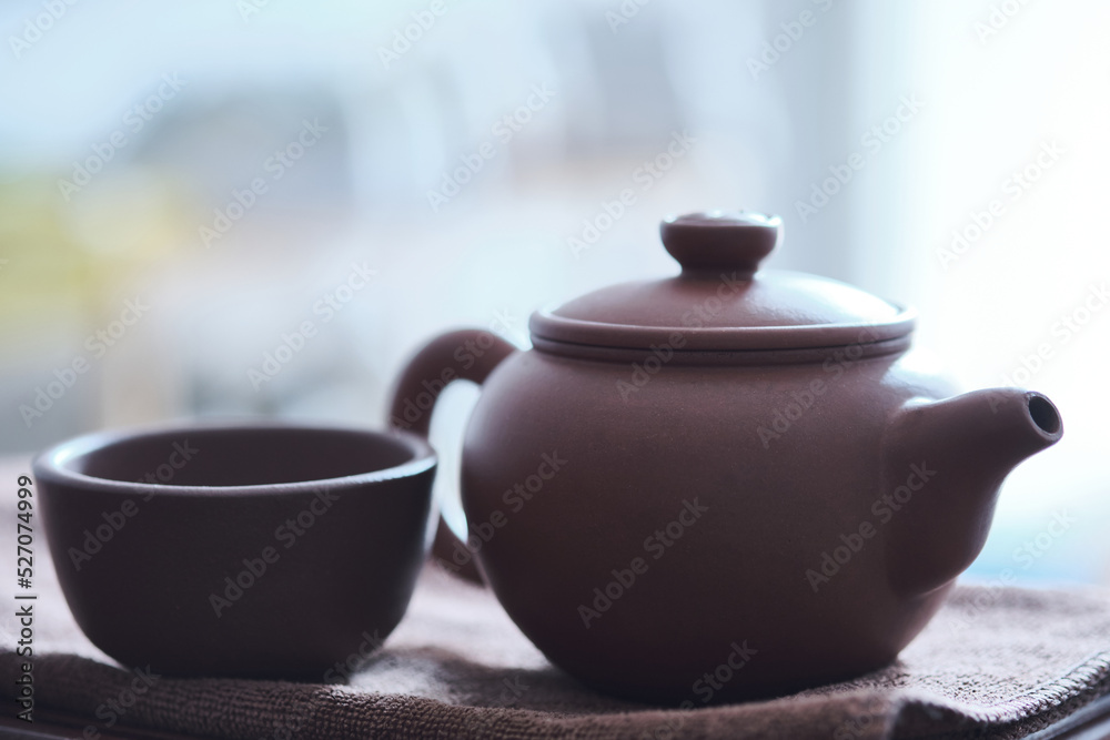 Traditional chinese tea ceremony utensils. Chinese brown clay teapot and cup. Tea brewing equipment