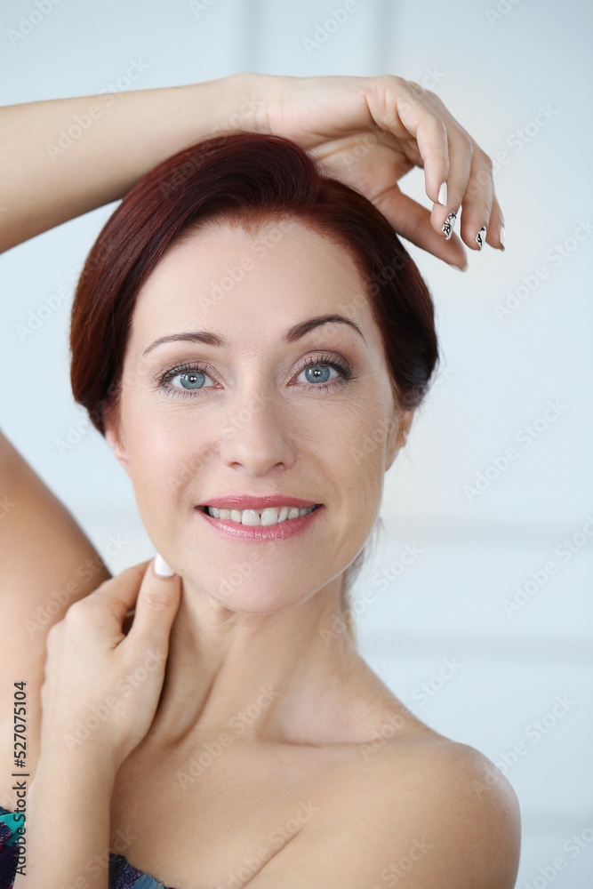 Close-up portrait of a beautiful,mature woman with blue eyes looking into the camera and smiling Close-up portrait of a beautiful,mature woman with blue eyes looking into the camera and smiling