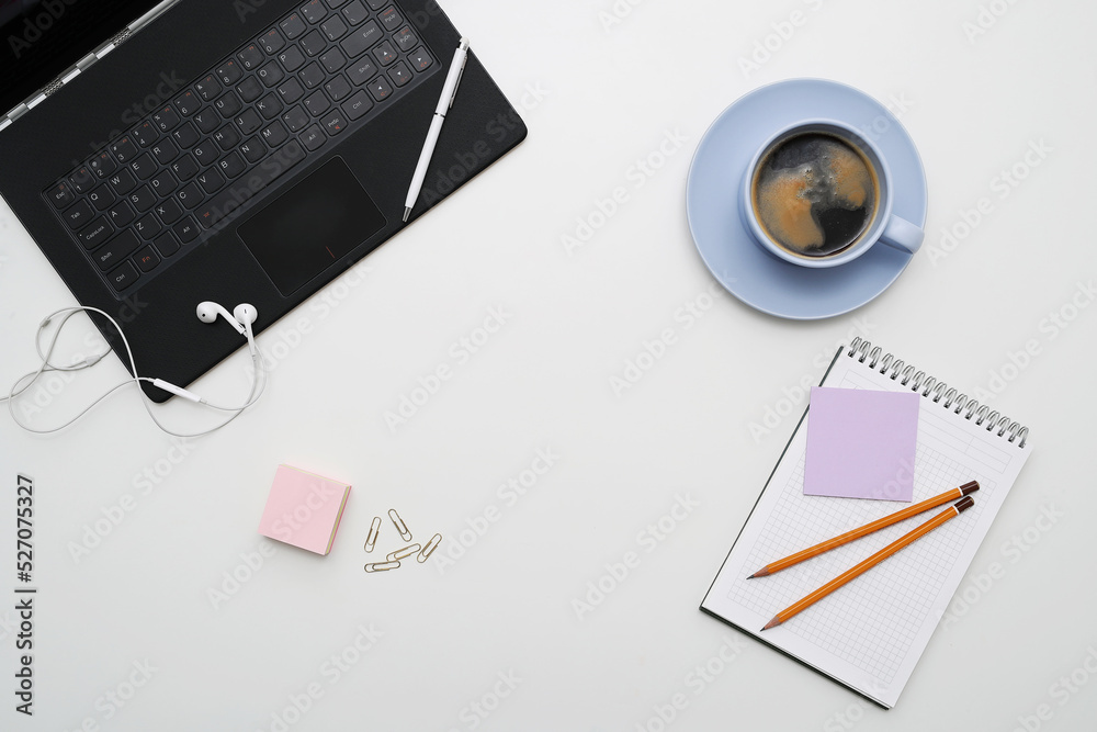Photo of different office stationary with a cup of dark coffee on a white background Photo of different office stationary with a cup of dark coffee on a white background