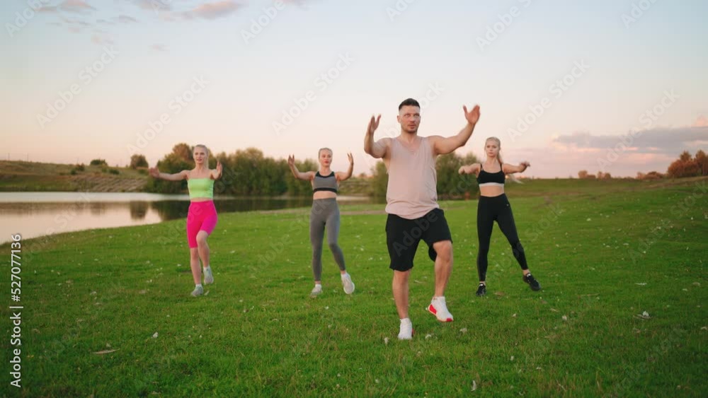 group fitness practice outdoors, people are training and enjoying morning nature in park, athletic women group fitness practice outdoors, people are training and enjoying morning nature in park, athletic women