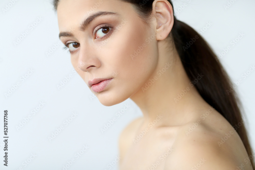 Close-up portrait of a young,beautiful,naked woman standing and looking into the camera