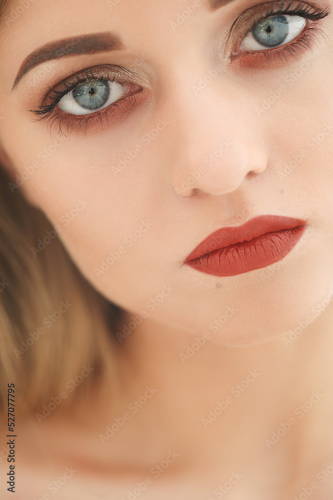 Close-up portrait of a young,blonde woman with bright makeup and blue eyes Close-up portrait of a young,blonde woman with bright makeup and blue eyes