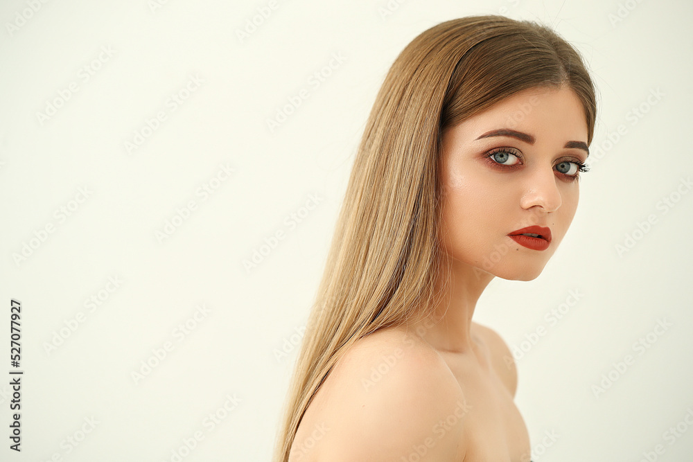 Close-up portrait of a young,blonde,naked woman with bright makeup and blue eyes Close-up portrait of a young,blonde,naked woman with bright makeup and blue eyes