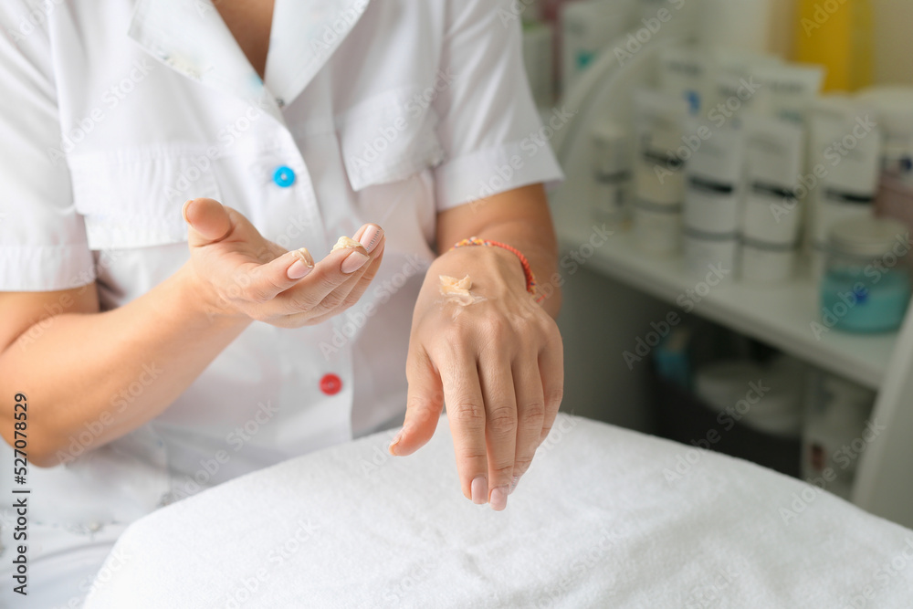 cold season hands skin protection. closeup woman applying protective cream on hands.