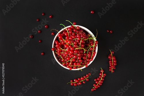 Fresh currant branches on dark background. Close up. Selective focus. useful product