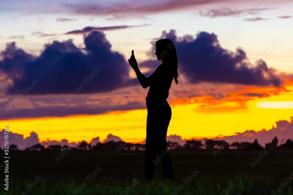 Woman photographs sunrise