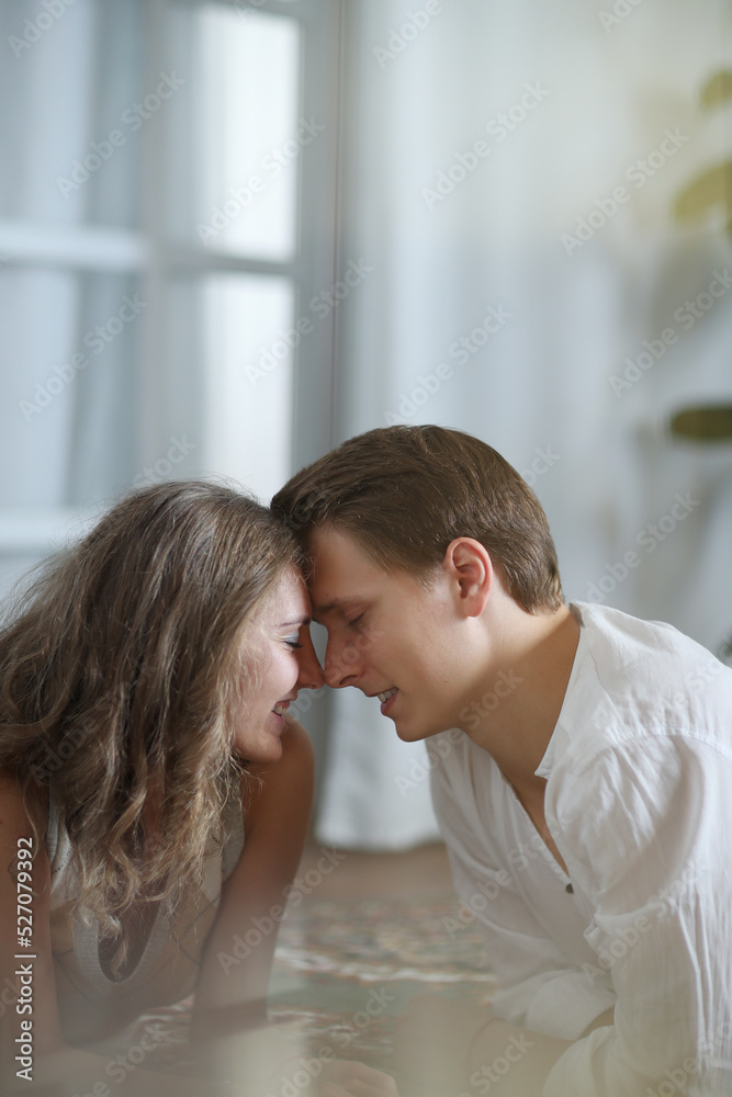 Photoshoot of a young couple of woman and man spending time on the carpet Photoshoot of a young couple of woman and man spending time on the carpet