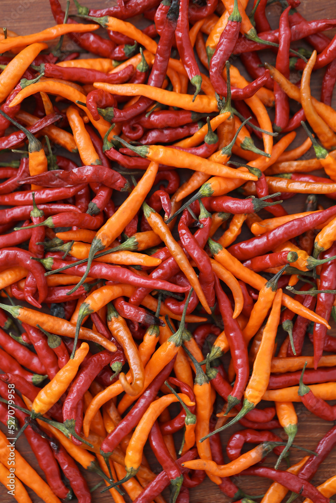 Fresh juicy red and yellow hot chili peppers isolated on a wooden background. Fresh juicy red and yellow hot chili peppers isolated on a wooden background.
