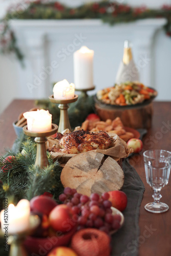 Festive Christmas dinner with candles on a wooden table