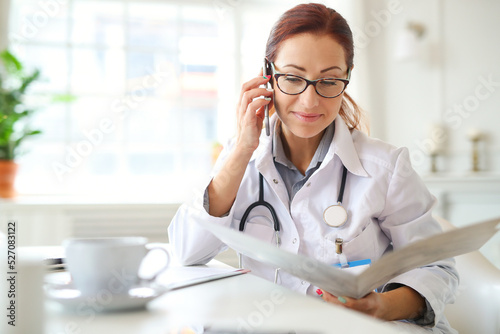 Female doctor having a phone call on medical office