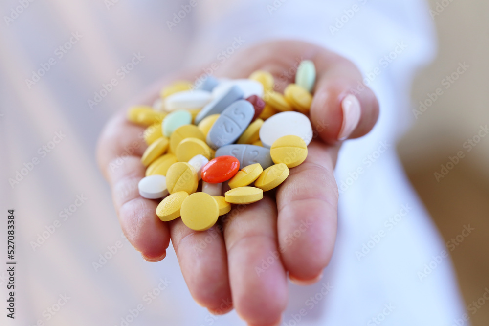 Many tablets of various medicinal drugs in the hand Many tablets of various medicinal drugs in the hand