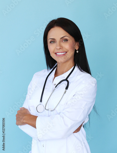 Laboratory worker with stethoscope standing with crossed arms on a blue background.