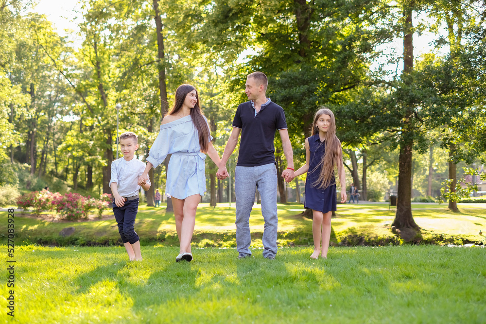 Mother, father and small son and daughter are having fun at the park. Mother, father and small son and daughter are having fun at the park.