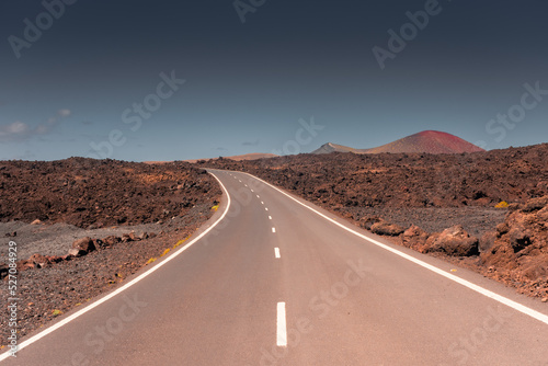 Empty road in the volcanic landscape of Timanfaya National Park, Lanzarote, Canary Islands,  Spain photo