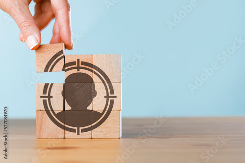 Woman hand put the wooden cubes focused on personalization icon. photo