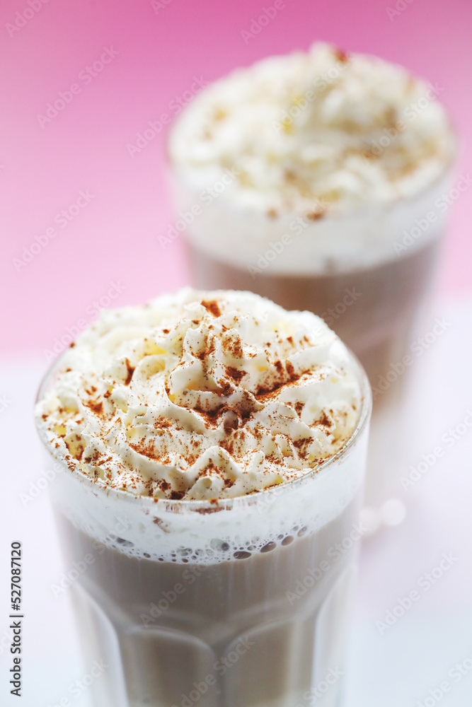 Close view of a tasty caramel milkshake on a pink background. Close view of a tasty caramel milkshake on a pink background.