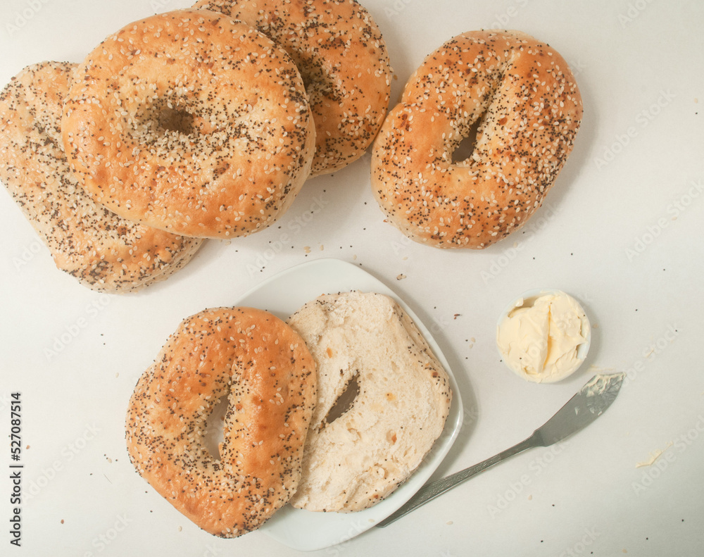 bagels with sesame seeds and chia, butter on a plate, kitchen top 