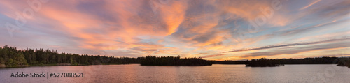 bright dramatic sunset over a forest lake