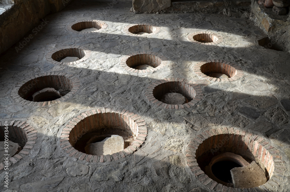 Production traditional Georgian wine in underground clay vessels called ...