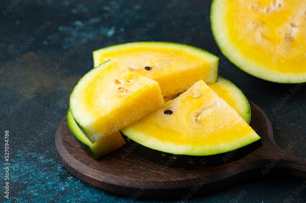 Cut yellow watermelon on table. Fresh summer food. Healthy nutrition Cut yellow watermelon on table. Fresh summer food. Healthy nutrition