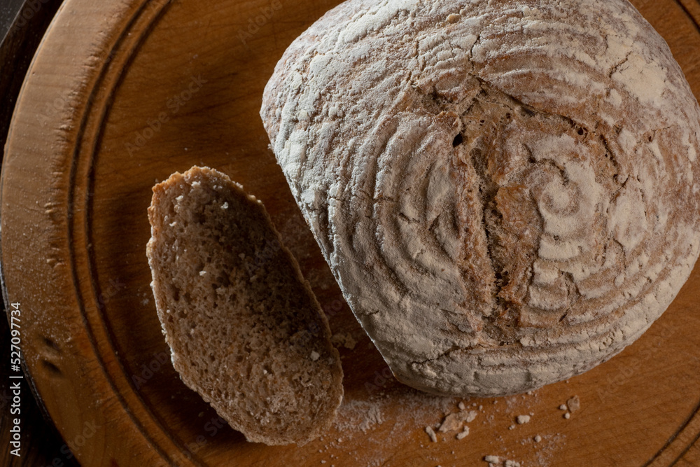 Brown San Francisco-style sourdough crusty bread. Top view. Brown San Francisco-style sourdough crusty bread. Top view.