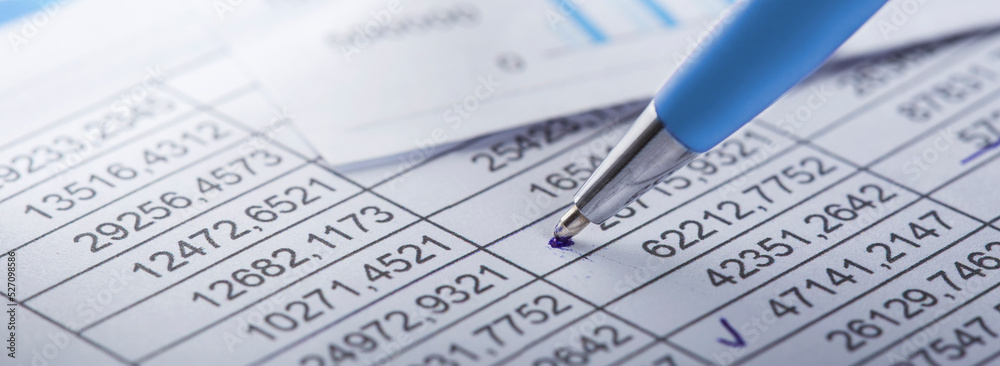 Accounting document with pen, money, coins and checking financial chart. Concept of banking, financial report and financial audit. Accounting document with pen, money, coins and checking financial chart. Concept of banking, financial report and financial audit.