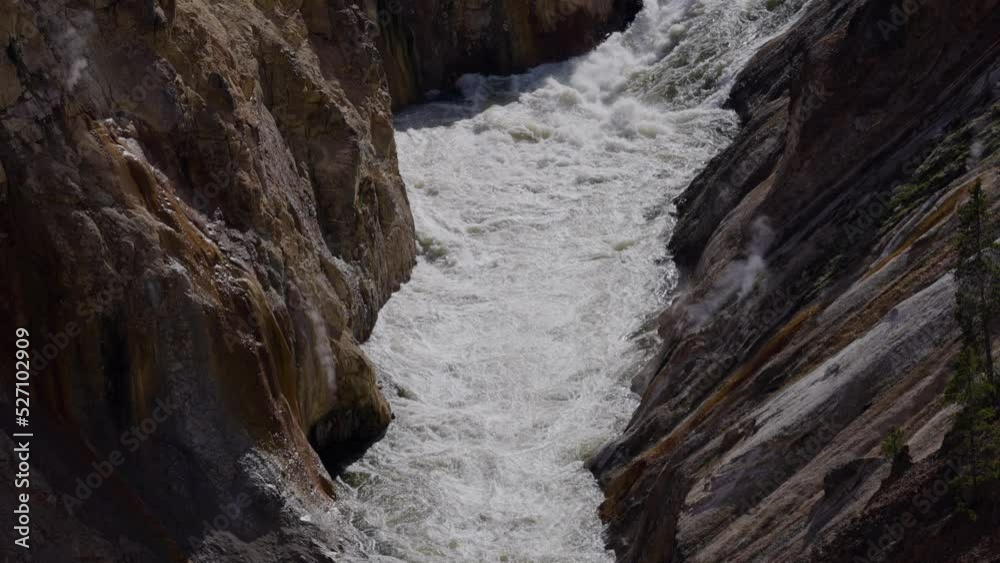 Rocky Canyon and River in American Landscape. Grand Canyon of The Yellowstone. Yellowstone National Park. United States. Nature Background. Slow Motion Rocky Canyon and River in American Landscape. Grand Canyon of The Yellowstone. Yellowstone National Park. United States. Nature Background. Slow Motion