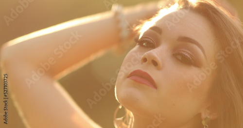 Sensuous young woman in hero 20s posing to camera in outdoor during sunset golden hour time