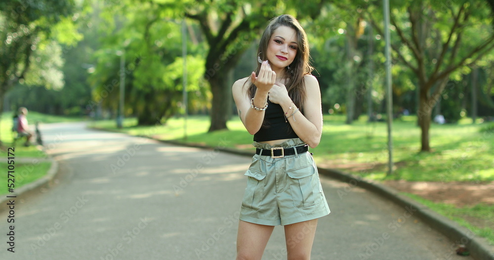 Pretty young woman inviting to come. Happy confident smiling girl making a gesture with hand, being positive and friendly Pretty young woman inviting to come. Happy confident smiling girl making a gesture with hand, being positive and friendly