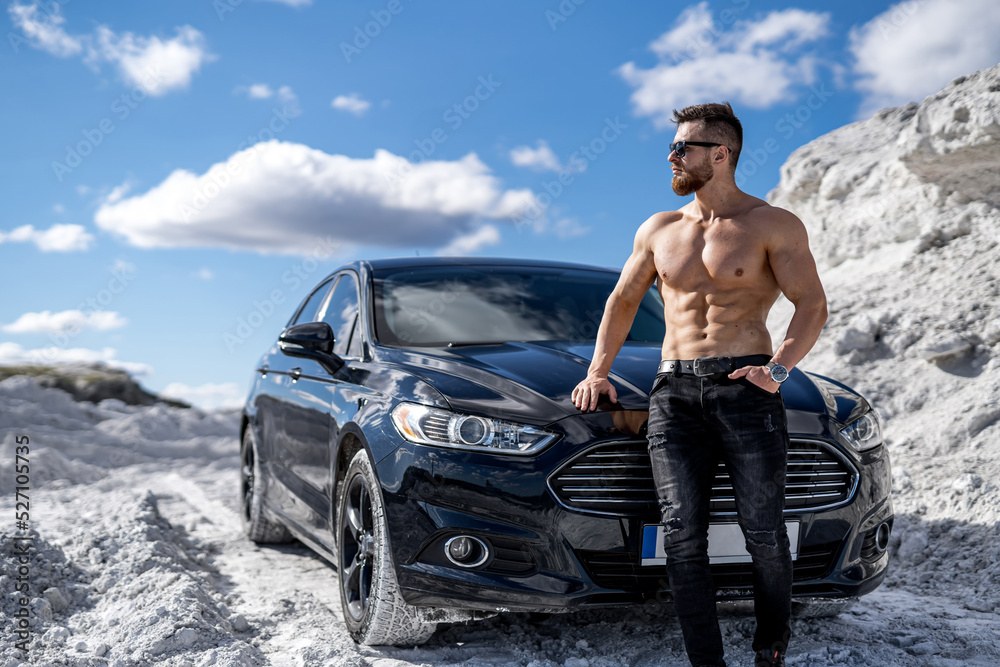 Fototapeta premium Shirtless muscular man with car. Naked fit macho with sexy torso.