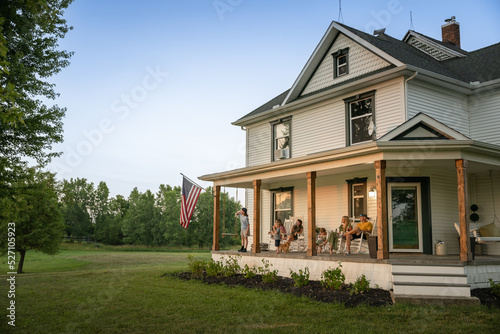 Quadro su tela Marine veteran at home with family during sunset on front porch.