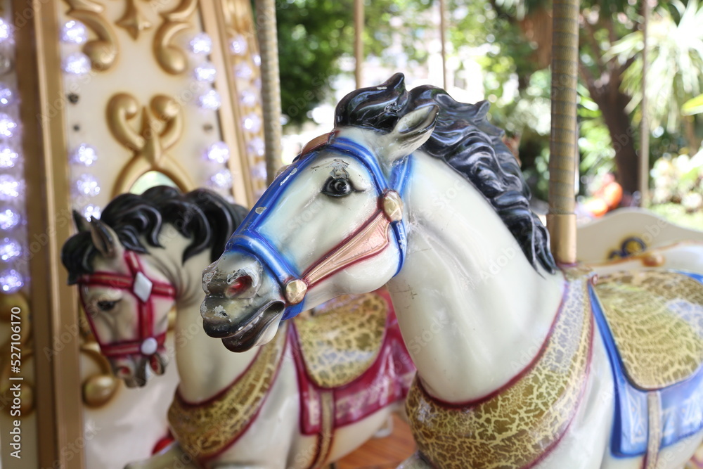 A close-up of the carousel with horses.  Carousel horse in a summer amusement park.