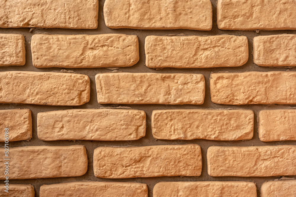 Fototapeta premium Sand colored decorative brick wall texture bg