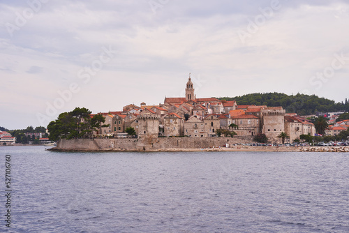Landscape picture of old town Korcula taken fom the adriatic sea during the cloudy summer day. Pitoresque historic old city on the Korcula island in south dalmatian region of Croatia.