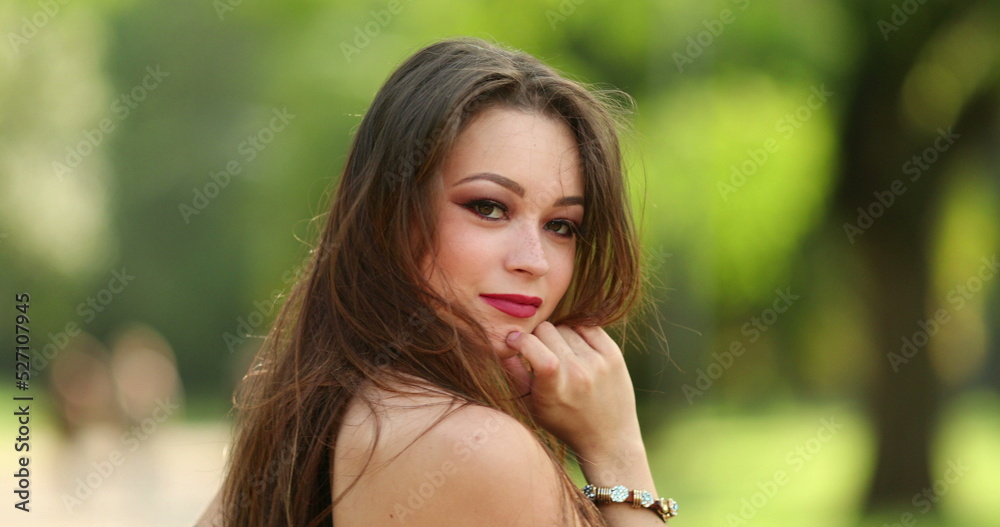 Pretty millennial girl posing in outdoor park nature Pretty millennial girl posing in outdoor park nature