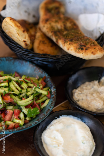 Israel and Lebanon cuisine served in restaurant. Middle eastern or Arabic Oriental restaurant. Several appetizer dishes and spreads for bread and salad. 