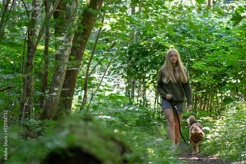 Woman and dog walking in forest