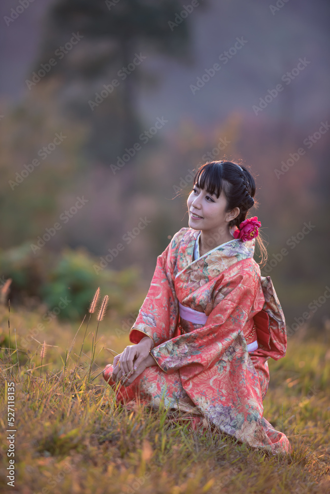 Young Asian woman wearing traditional Japanese kimono in the park in the morning.
Young Asian woman wearing traditional Japanese kimono in the park in the morning.