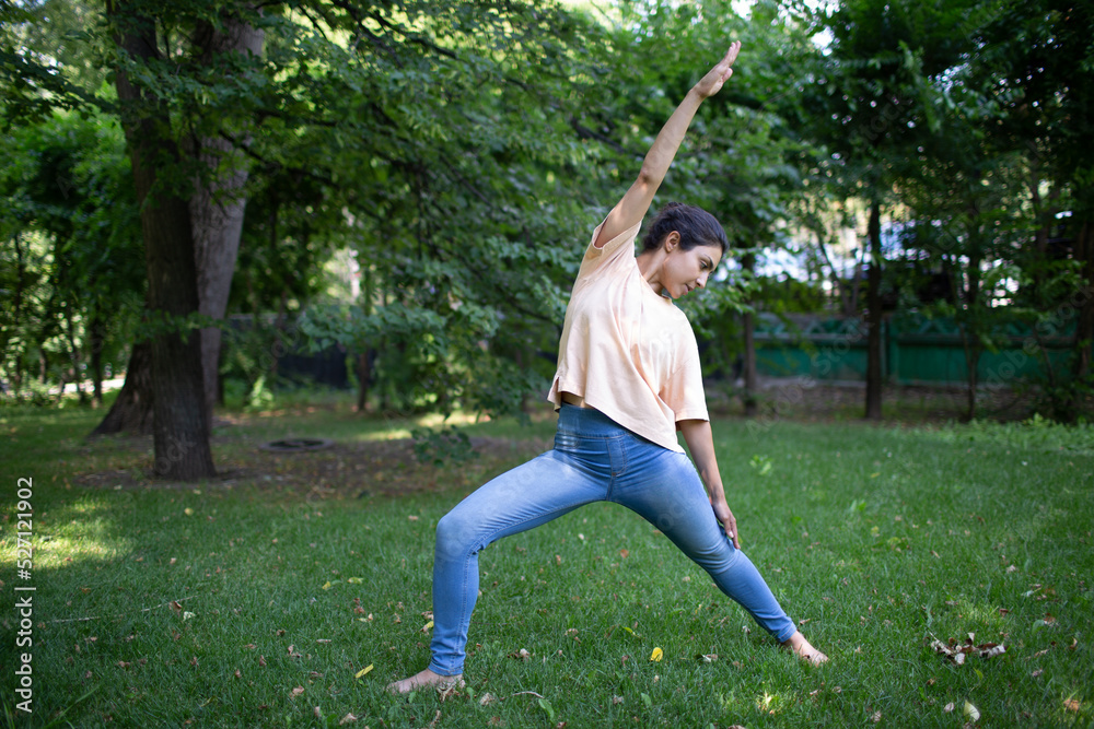Indian woman doing yoga in outdoor summer park. Indian woman doing yoga in outdoor summer park.