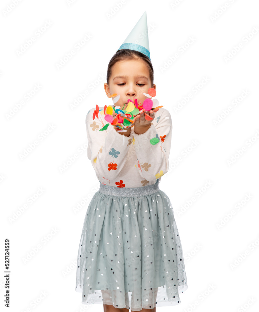 birthday, childhood and people concept - little girl in party hat blowing to confetti over white background birthday, childhood and people concept - little girl in party hat blowing to confetti over white background
