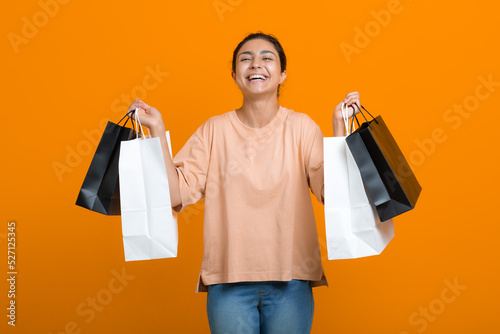 Indian woman holds shopping bags in hands. Sale and Black Friday concept