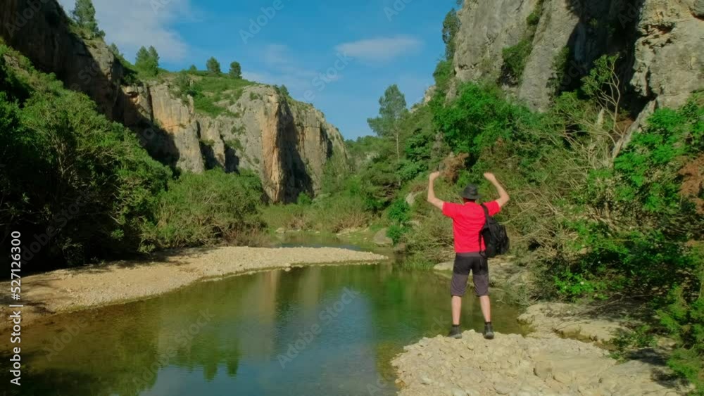 Man is dancing with a backpack. Male is hiking in nature. Man is dancing with a backpack. Male is hiking in nature.