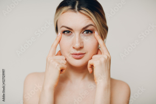 Young adult doing facial gymnastics self massage and rejuvenating exercises face building and lifting