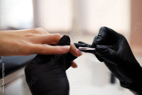 Manicure process female hands finger nails lacquer applying nail polish.