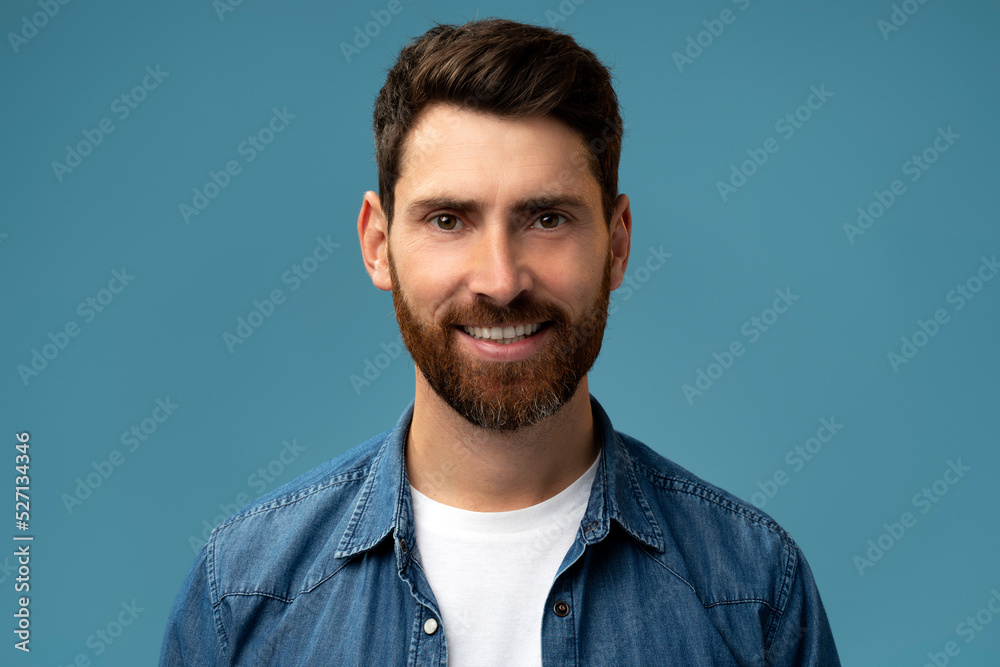 Portrait of bearded handsome man in casual style looking at the camera and smiling Portrait of bearded handsome man in casual style looking at the camera and smiling