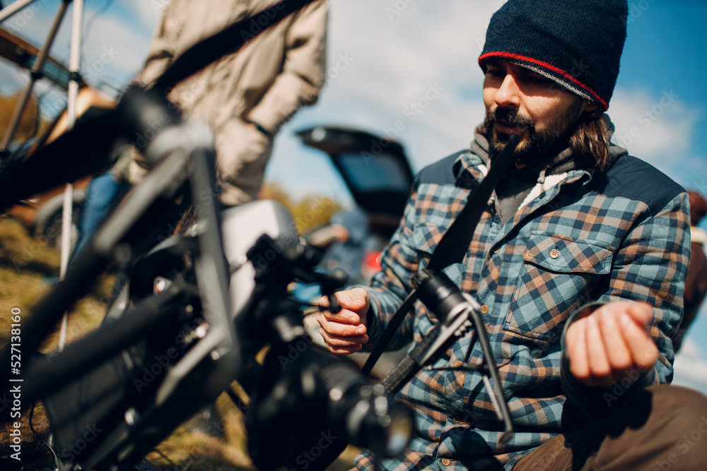Fototapeta premium Man pilot checking quadcopter drone before aerial flight and filming